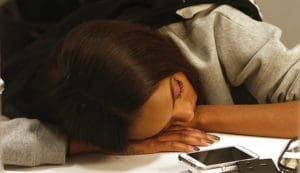 A model sleeps backstage before the presentation of the Burberry Prorsum Spring/Summer 2014 collection during London Fashion Week