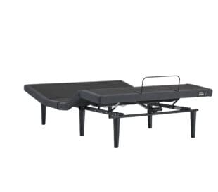 An adjustable black bed frame with raised head and foot sections, metal legs, and a mattress retainer bar at the foot.