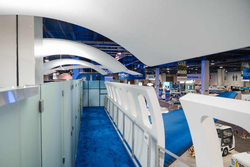 Upper deck meeting space inside TLD’s double-deck exhibit, showcasing aviation innovation through creative trade show design.