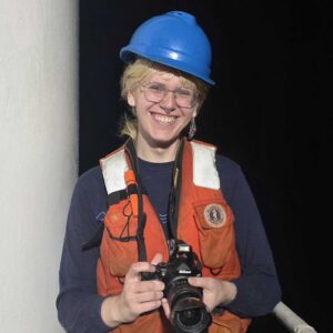 smiling person in blue hard hat