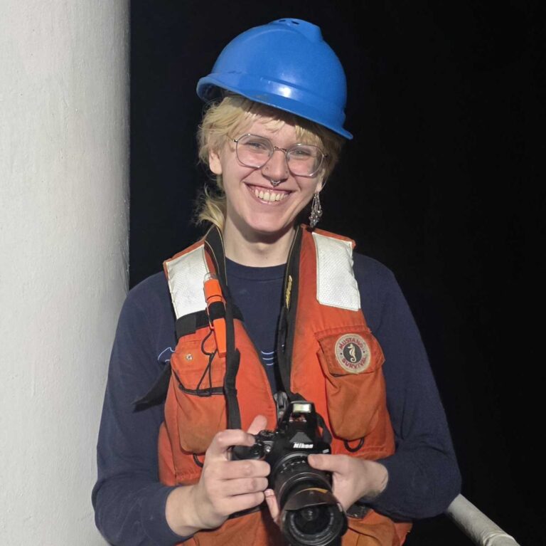 smiling person in blue hard hat