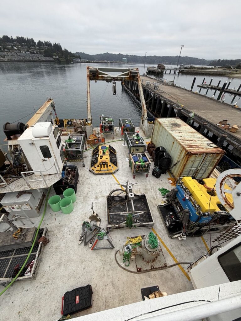 Back deck of a ship filled with oceanographic equipment