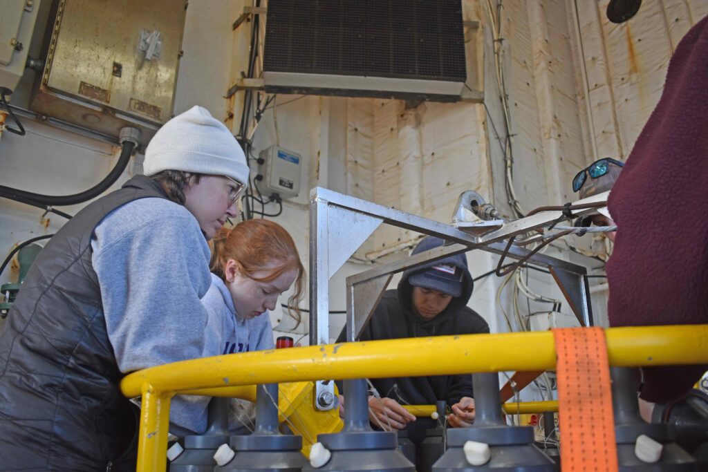 VISIONS'26 students - Maddie, Avery, and Justin - receive training on the CTD. K. Bigham, University of Washington, 26.