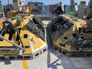 Two BEP’s on the Revelle fantail. A BEP that will be deployed at the Oregon Offshore site (Left) and one recovered from the Oregon Shelf site deployed in 2025. (Right). Credit: A. Wolf, University of Washington; V26.