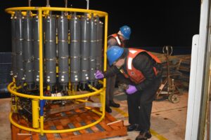 Justin collecting water sample from Niskin on CTD. Credit: J. Thirtyacre, University of Washington; V26.