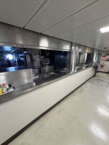 Buffet style serving area in the galley with counters and serving openings in the front of the area where food is prepared.