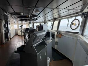 Bridge on the Revelle wrapped by large windows and numerous stations for radars and ship controls.