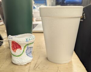 A shrunken cup adjacent to an original 8 oz.