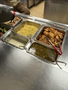 Blackened chicken and pasta alfredo in warming dishes for dinner.