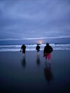 Students Izzie, Avery, and Justin walking on the Yaquina Beach. Credit: A. Chang, University of Washington; V26