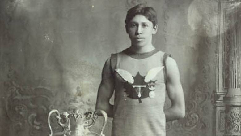 Legendary Haudenosaunee runner Tom Longboat poses beside the trophy he won in the 1907 Boston Marathon. Longboat died in 1949 at age 62. (Charles A. Aylett/Library and Archives Canada  - image credit)