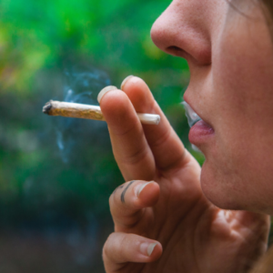 a woman smokes a legal cannabis joint