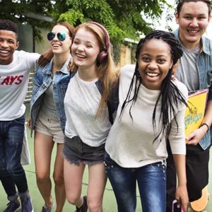 group of teens having fun walking down the street
