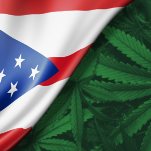 The flag of Ohio pulls back to reveal marijuana leaves
