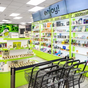 Shopping carts at the entrance of GreenPharms, facing bright aisles and open shelves.