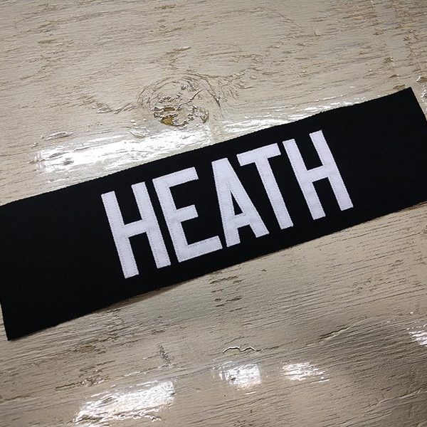 Custom jersey nameplate, black nameplate with white text