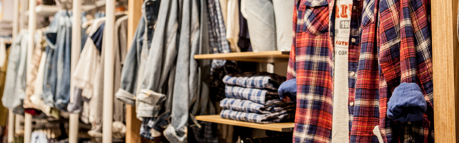 Retail store shelves showing a variety of colorful clothing, fabrics, and footwwear.