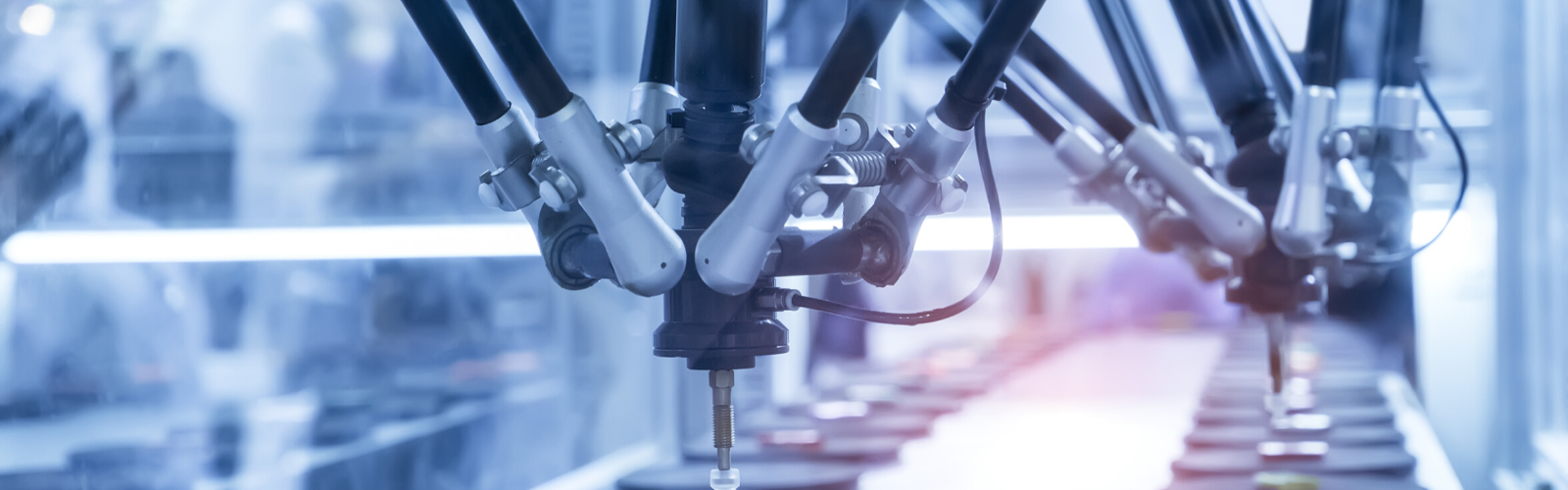 Medical device manufacturing facility with mechanical arms creating round parts that will be used on medical devices.
