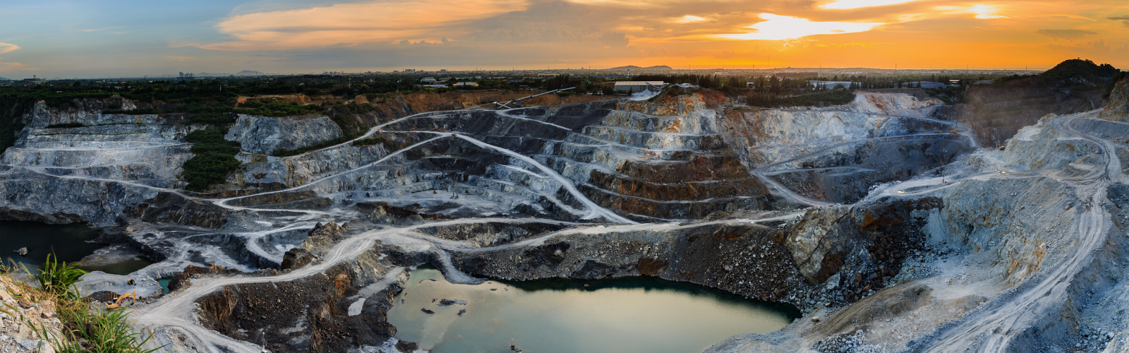 Ariel view of a Cobalt or Mica mine nestled in the mountains at sunset.