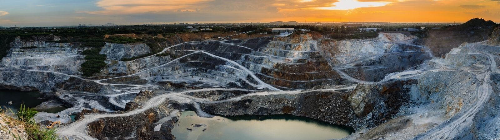 Ariel view of a Cobalt or Mica mine nestled in the mountains at sunset.