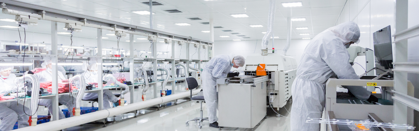 Bright white laboratory with technicians working at computer reviewing safety data sheets.
