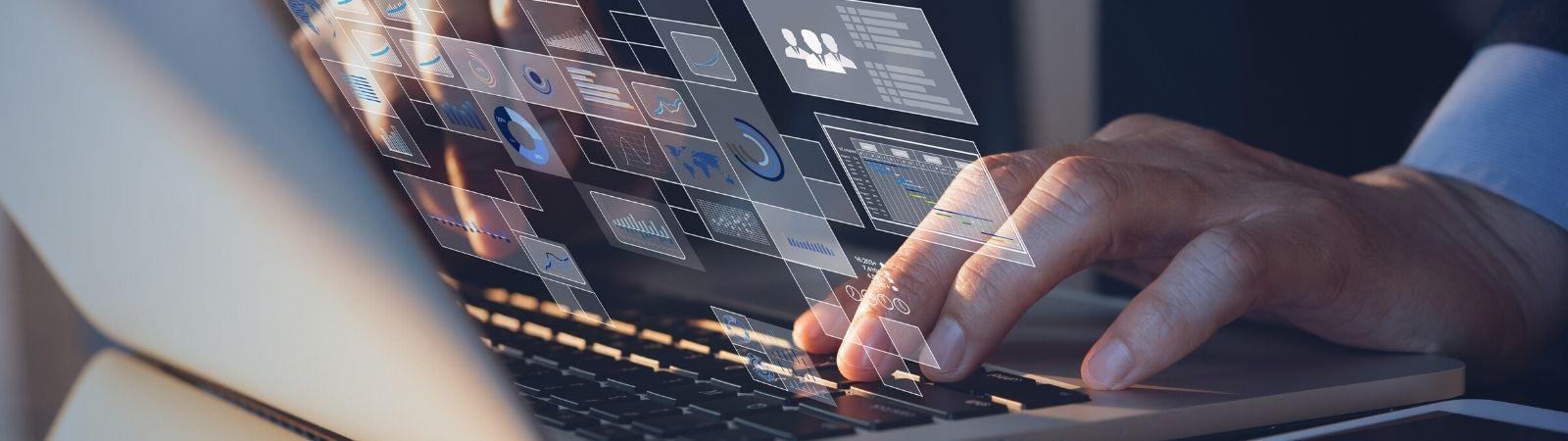 Businessman typing on a laptop reviewing virtual supplier audit results, data points, and data visualizations.