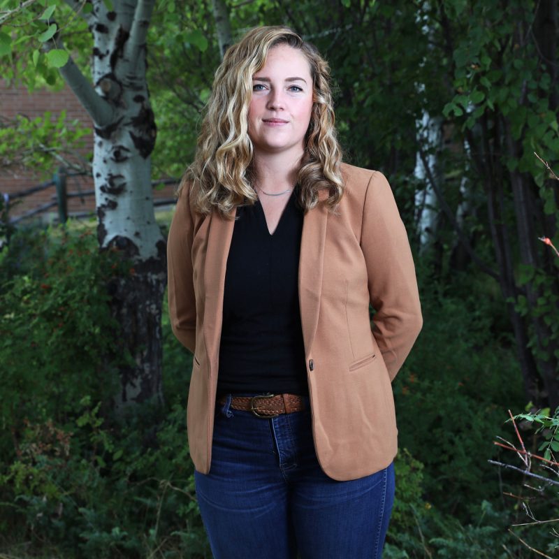 Kate standing in front of an apen grove.