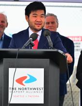 Commissioner Cho speaks at a podium