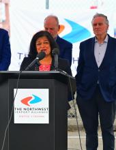 Congresswoman Jayapal speaks at a podium