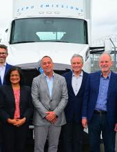 people posed in front of a zero emission truck