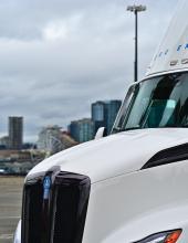 an electric truck with seattle in the background