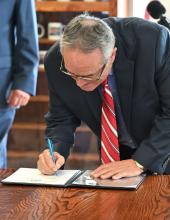 Northwest Seaport Alliance Co-chair Dick Marzano signs an interlocal agreement during a signing ceremony on Thursday, February 5, 2026.