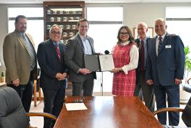 Officials gather for a group photo after signing an interlocal agreement to develop an Inland Logistics Hub in southeastern Washington during a ceremony in Olympia on Thursday, February 5, 2026. 