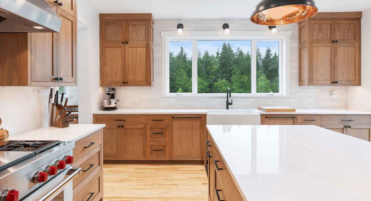 a kitchen with wood cabinets and a window