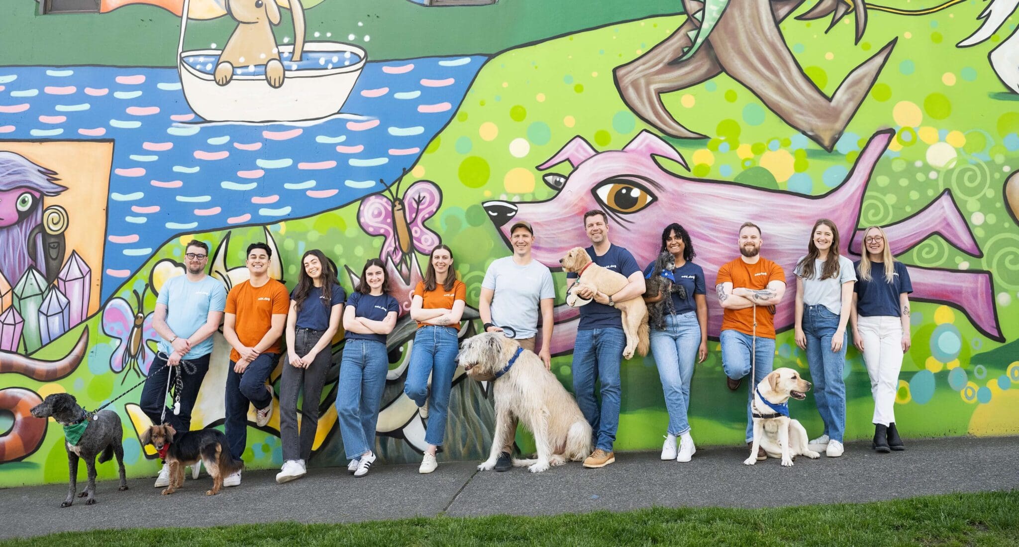Seattle marketing agency team photo in front of a Henry mural - contact Odd Dog
