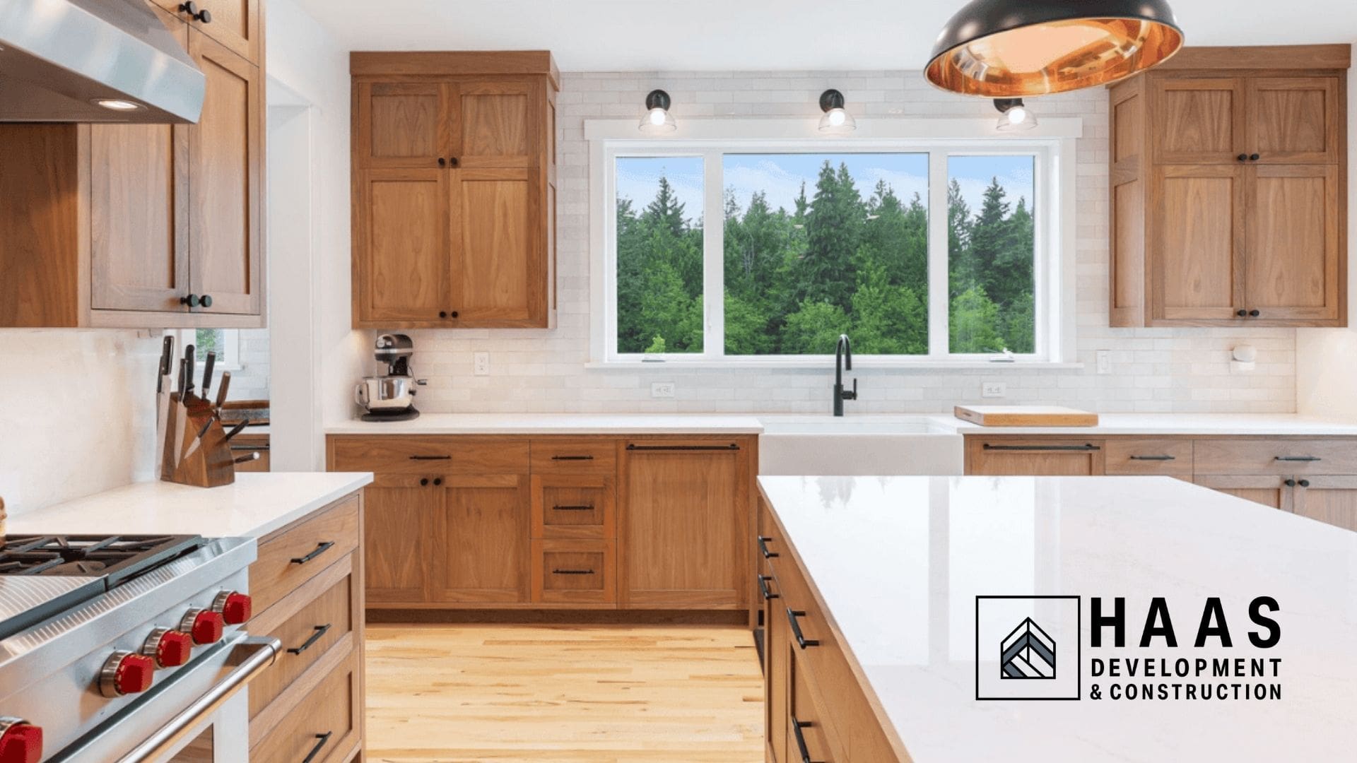 Bright & spacious kitchen with wood cabinets, marble countertops, and large window
