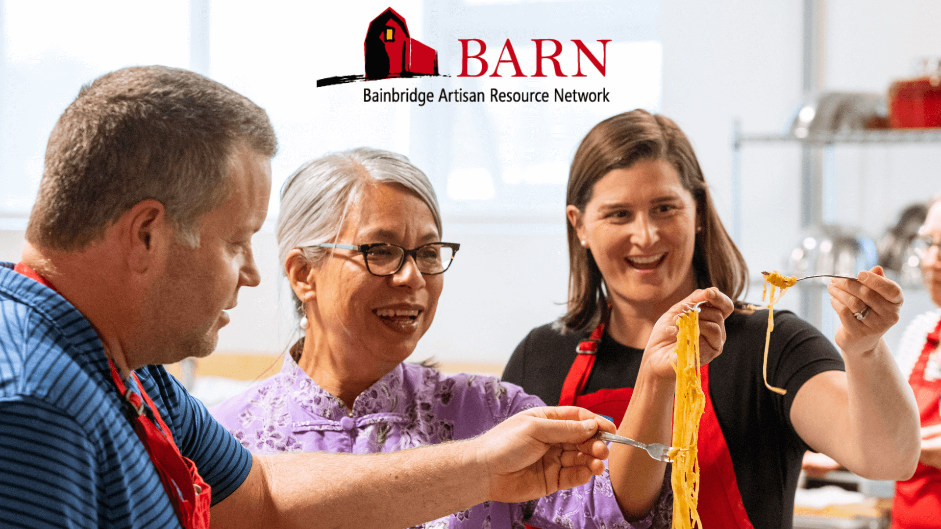 Three people admiring the pasta they made in a BARN cooking class.