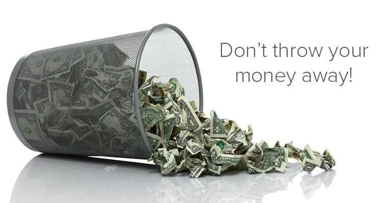 A trash can full of crumpled money spills over