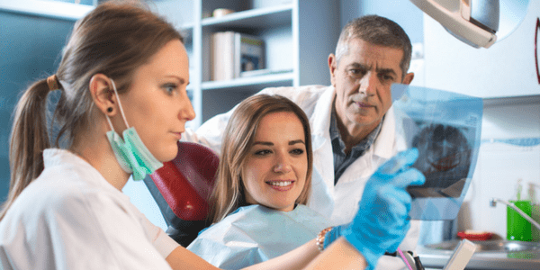 Dental team discussing X-ray results with their patient