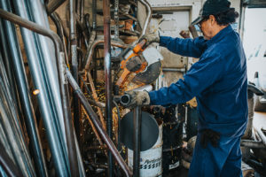 muffler being cut down at Bucky's Auto Repair Federal Way