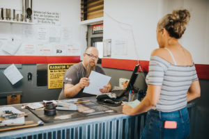 cashier offering a payment plan available at the lynnwood Bucky's Muffler Brakes & Radiator