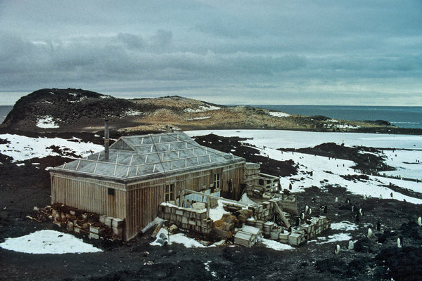 Shackleton’s Hut, inspected by Adelie penguins, in 1981. Because of the Antarctic’s punishing conditions, permanent bases there need constant attention and repair.