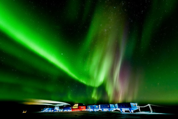 An aurora australis visible over Halley VI during an Antarctic winter night.