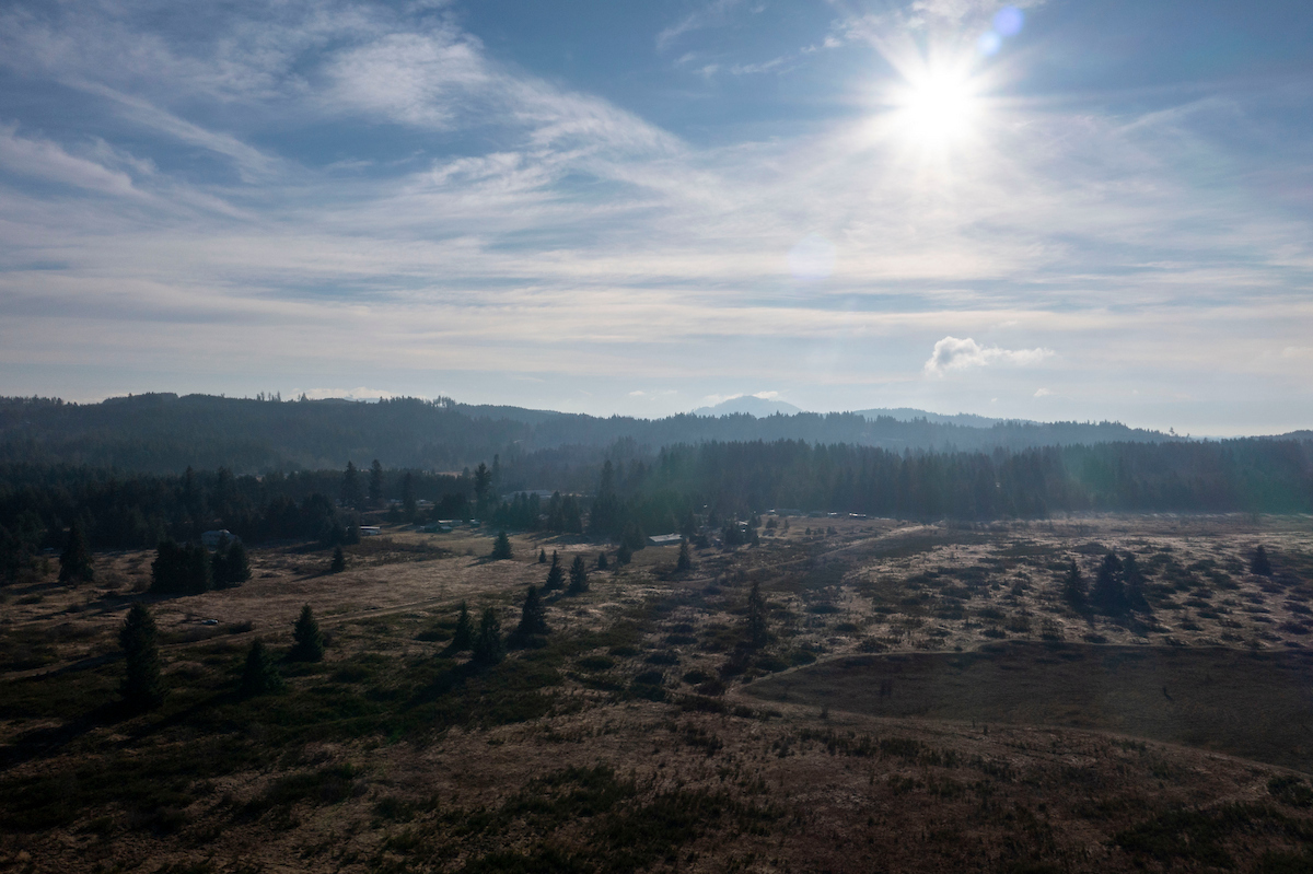 An aerial shot of a plot of land with sunny skies.