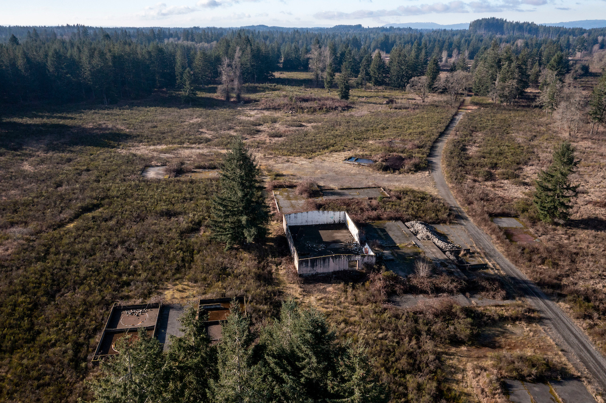 An aerial shot of an unfinished structure next to a road.