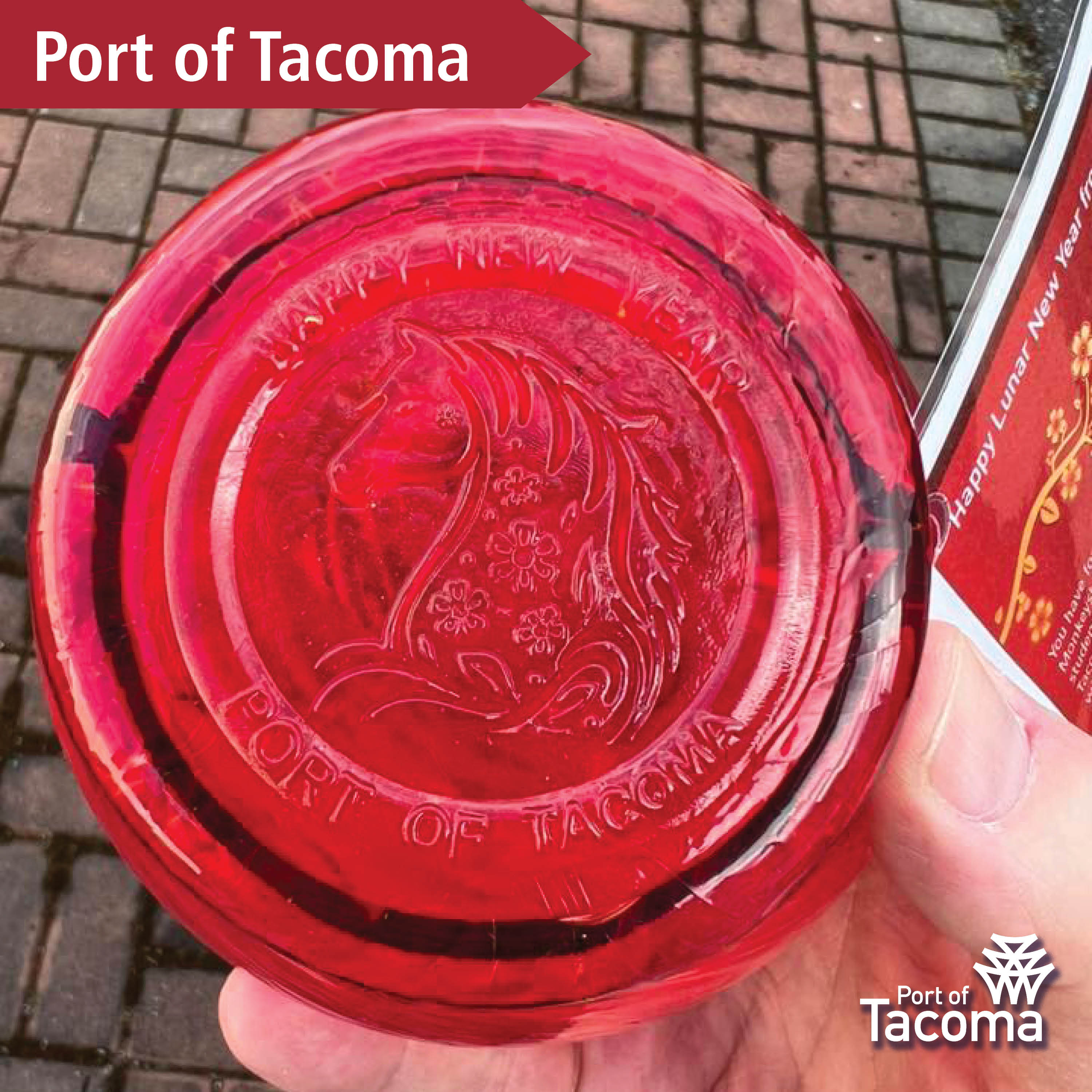 Up close shot of a red Monkeyshines token with the words "Port of Tacoma" typed in the corner