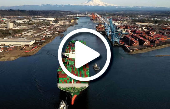 Aerial shot of a ship coming into Port on a clear, sunny day.