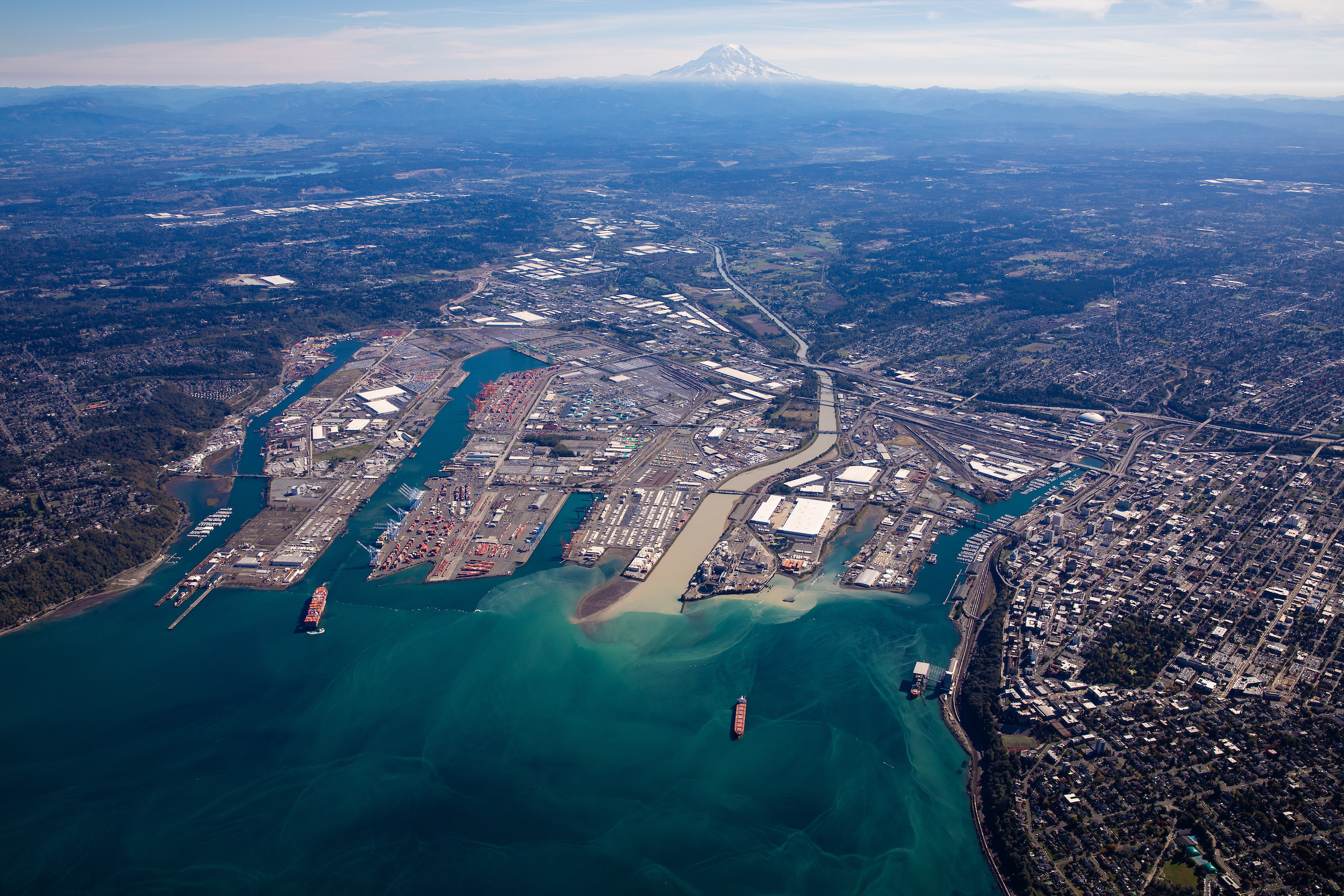 Aerial view of the Port of Tacoma in the Tacoma Tideflats with Mount Rainier in the background.