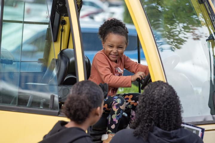 Smiling child in a truck.