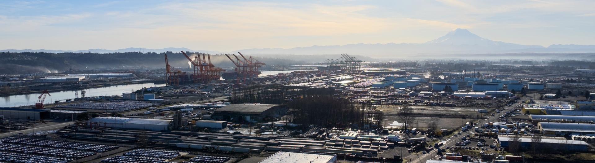 Aerial shot of the Port of Tacoma on a sunny day with Mount Rainier in the background